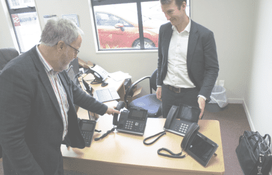 Manager viewing phone representing Managed IT services